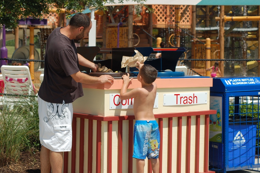 Image of family putting waste in composte bin